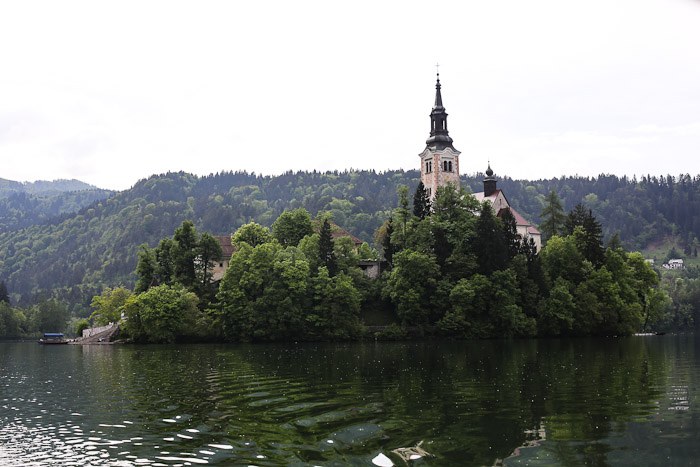 Eastern Europe Slovenia Travel Tourist Lake Bled Pletna Boat Church Mary Row Oars Mountains Steps Monk Stairs Legend Tradition Water Serene Green Scenic