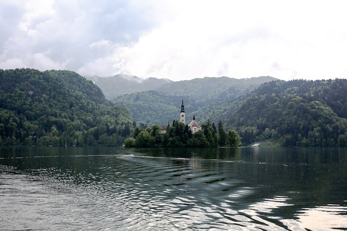 Eastern Europe Slovenia Travel Tourist Lake Bled Pletna Boat Church Mary Row Oars Mountains Steps Monk Stairs Legend Tradition Water Serene Green Scenic