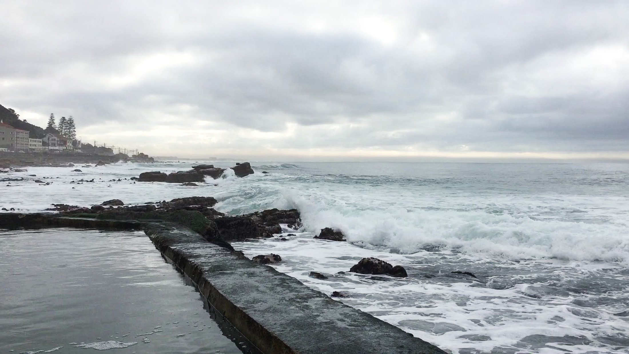 Men fishing from the beach on False Bay at Muizenburg in the