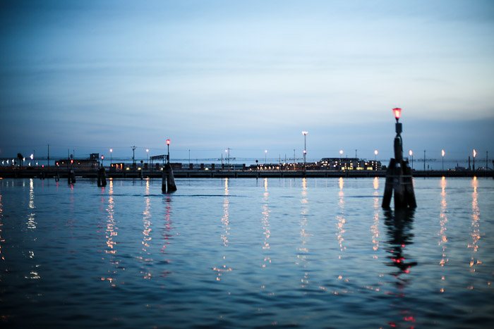 europe italy travel lagoon sea ocean water lights glimmer pier reflection sunset color